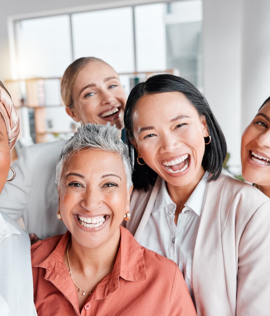 Diverse group of women smiling together in celebration